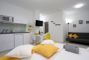 a living room with a couch and a kitchen at Guesthouse Villa DomeNico in Lozovac