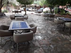 a group of tables and chairs with lights on them at Hotel France Ouzoud in Ouzoud