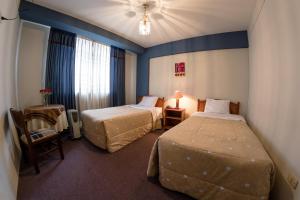 Postel nebo postele na pokoji v ubytování Hotel T'ika