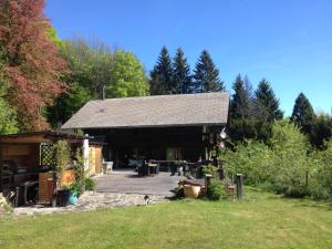 a large building with a patio in a yard at Chalet Ingas in Troistorrents