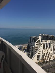 a view from the balcony of a building near the ocean at Orbi residence design studio in Batumi