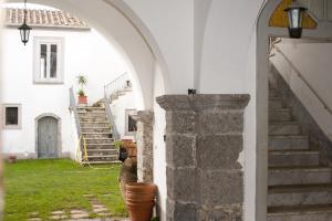 an archway leading into a white house with stairs at Palazzo D'Orsi in Calvanico