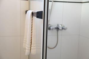 a shower with a glass door with a towel at Complejo las Morochas in Valeria del Mar +41 photos
