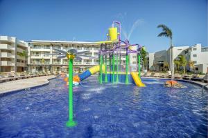 a water park with a water slide in a pool at Royalton Negril, An Autograph Collection All-Inclusive Resort in Negril