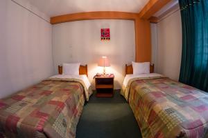 Postel nebo postele na pokoji v ubytování Hotel T'ika