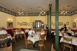 a group of people sitting at tables in a restaurant at Historic Plaza Hotel in Las Vegas