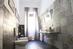 a bathroom with a toilet and a sink at Dimi House in Lecce