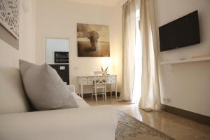 a living room with a couch and a table and a television at Dimi House in Lecce