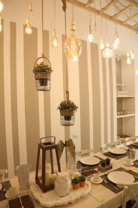 a table with plates and potted plants on it at Dimi House in Lecce