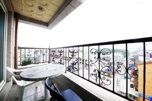 a balcony with a table and a view of a city at Drama Motel in Boryeong