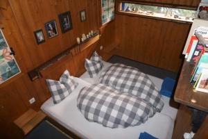 a bedroom with two pillows on a boat at Almhaus Goldeck in Schwaig