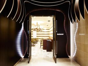 a hallway with a door leading to a dining room at S.Training Center Hotel Osaka in Osaka