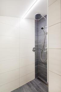 a shower in a bathroom with white walls at Martina und Herbert Scherer in Wagrain