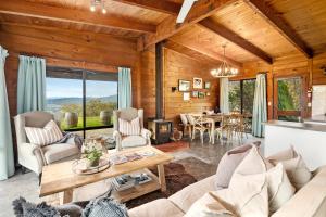 a living room with a couch and a table at The Lodge by Mt Bellevue in Myrrhee