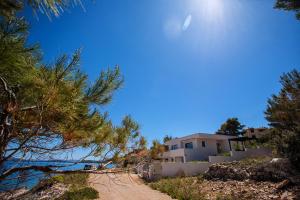a house on the beach next to the ocean at House , Seafront Apartment Pelegrin in Stomorska