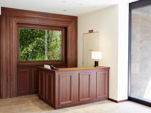 a reception desk in a lobby with a window at S.Training Center Hotel Osaka in Osaka