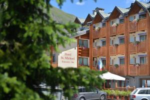 a hotel with cars parked in front of it at Hotel St. Michael in Livigno