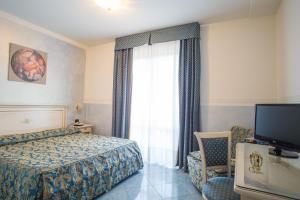 Postel nebo postele na pokoji v ubytování Hotel Confine