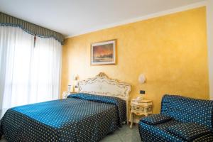 Postel nebo postele na pokoji v ubytování Hotel Confine