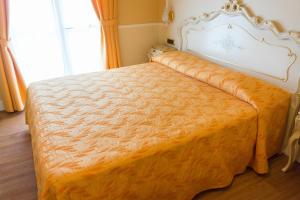 Postel nebo postele na pokoji v ubytování Hotel Confine