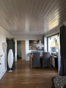 a dining room with a table and a chandelier at Harzhome in Herzberg am Harz