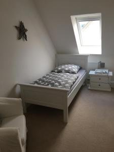 a bedroom with a bed and a window at Harzhome in Herzberg am Harz