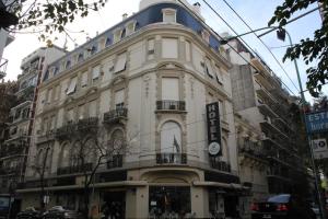 a large white building on the corner of a street at Ayacucho Palace Hotel in Buenos Aires