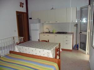 a small kitchen with a bed in a room at Canto delle Rane in Vieste