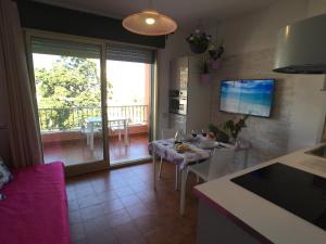 a kitchen and dining room with a table and a balcony at Residence Imperiale in Sanremo