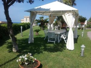 a white gazebo with a table and chairs at Villa Sara B&B in Civitavecchia