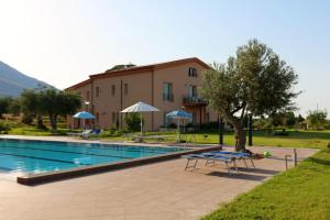 a swimming pool in front of a building at Case Mistretta in Altavilla Milicia