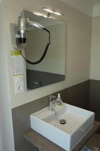a bathroom with a white sink and a mirror at Hotel le Préjoly in Saint-Vallier-de-Thiey +33 photos
