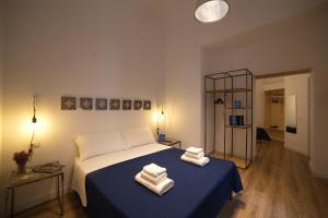 a bedroom with a bed with two towels on it at Borgo Vergini Garden B&B in Naples