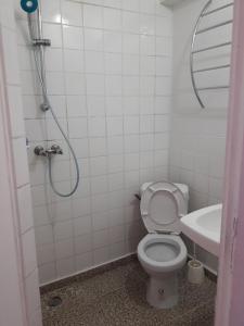 a bathroom with a shower and a toilet and a sink at Hôtel Du Centre in Saint-Denis +38 photos