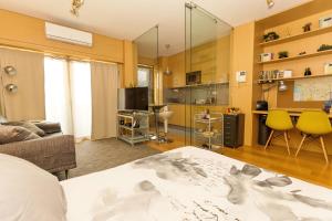 a living room with a bed a couch and a kitchen at Studio Apartment Porto Gaia (Arrabida) in Vila Nova de Gaia