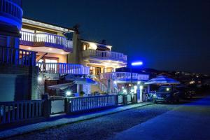 a building with blue lights on it at night at Peramos Rent House in Néa Péramos