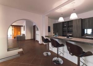 a kitchen with a counter and chairs in a room at Villa Crawford in San Nicola Arcella