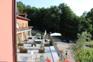 a balcony of a building with a patio with plants at Hotel Bocciolo in Orta San Giulio