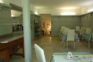 聖瓦利耶-德蒂耶的住宿－普羅樂酒店，用餐室配有桌子和白色椅子