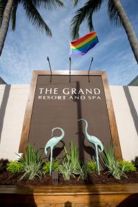 
a statue of a bird sitting on top of a sign at The Grand Resort and Spa - All Male Spa Resort in Fort Lauderdale
