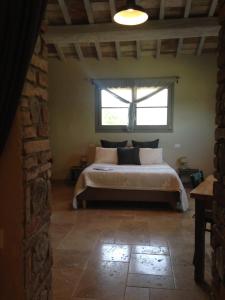 a bedroom with a large bed with a window at Le Palazze B&b in Chiusi
