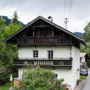 a white house with a balcony on the side of it at Haus Loferer in Sankt Martin bei Lofer