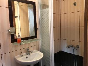 a bathroom with a sink and a mirror at Gościniec Kukle in Kukle +56 photos