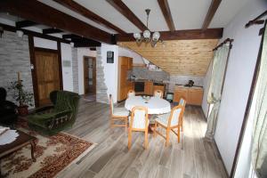 a kitchen and dining room with a table and chairs at Apartment Mihalic in Ogulin