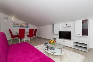 a living room with a couch and a glass table at Apartments Villa-Ines Center in Vodice