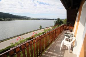 a balcony with a table and a chair and a view of a river at Apartment Mihalic in Ogulin