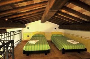 En eller flere senge i et værelse på Terre Del Cantico Country House