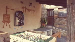 a room with a pool table and a clock on the wall at Casa Rural El Peral in Caminomorisco