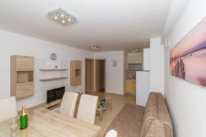 a kitchen and dining room with a table and chairs at Apartments Villa-Ines Center in Vodice