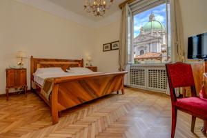 a bedroom with a bed and a large window at Hotel Vittoria in Brescia